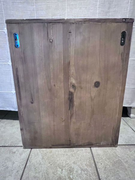 the finished wood cabinet with a blue light on top.