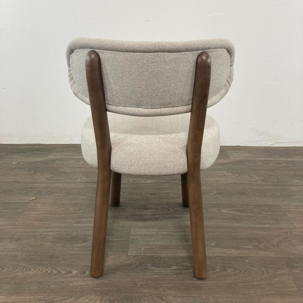 Brand new Reperch Jane dining chair with an elegant curved back and sculptural wooden legs, seat height 19.5 inches.