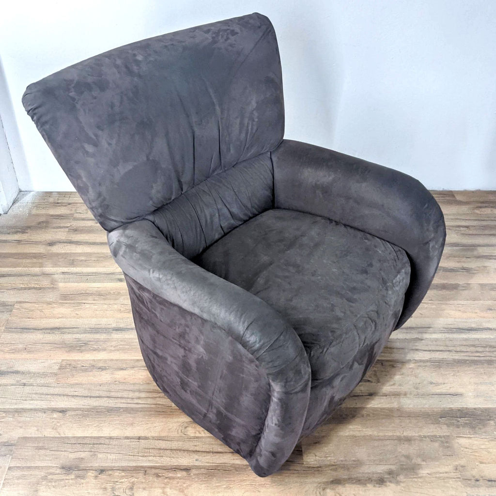 Angled view of a plush Reperch gray suede lounge chair with swivel base.