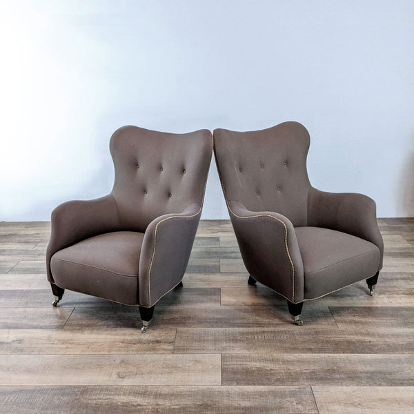 Alt text 1: Two RomI mini lounge chairs by Cisco Brothers, brown with tufted backs, contrasting beige piping, and boot casters on a wooden floor.