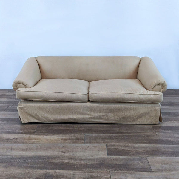 Alt text 1: Reperch classic slipcover two-seat sofa with a straight back, sloped rounded arms, and skirt on wood floor.