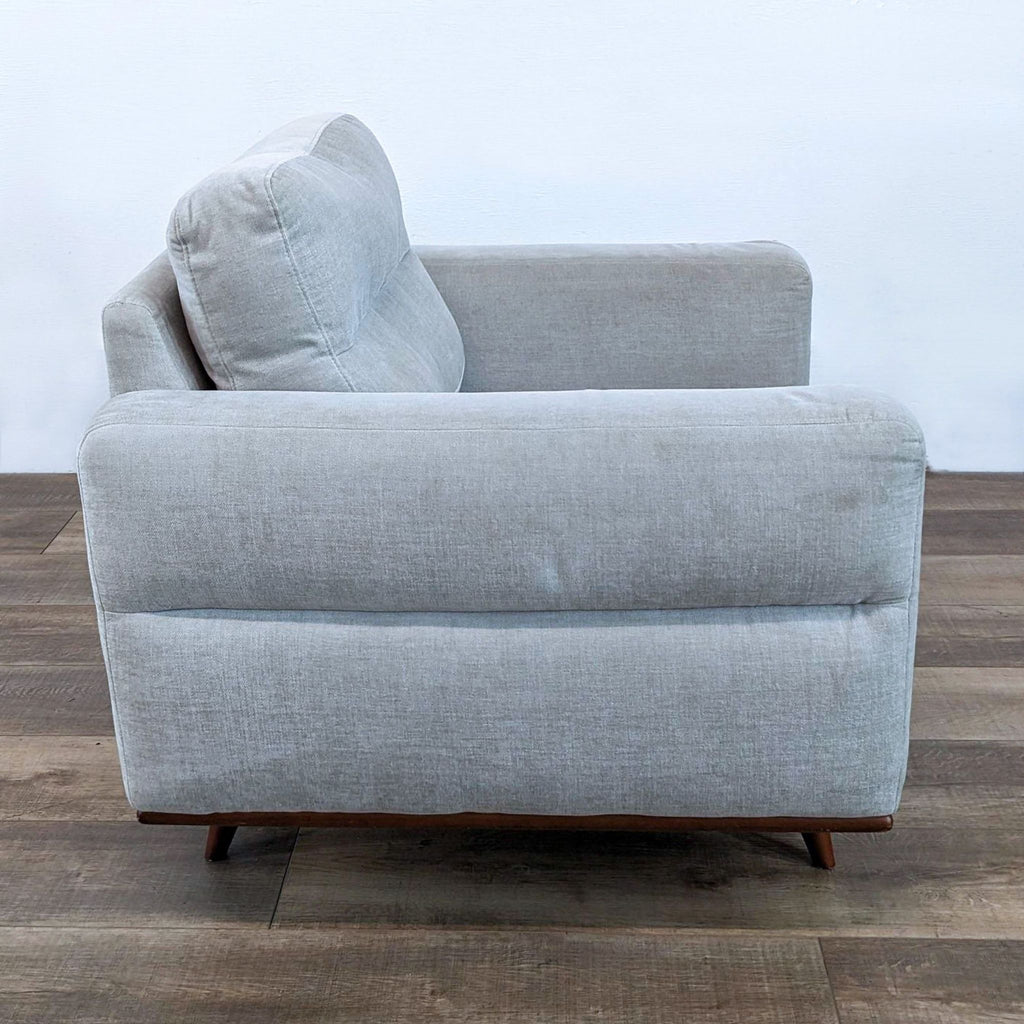 a couch with a black leather couch cushion 