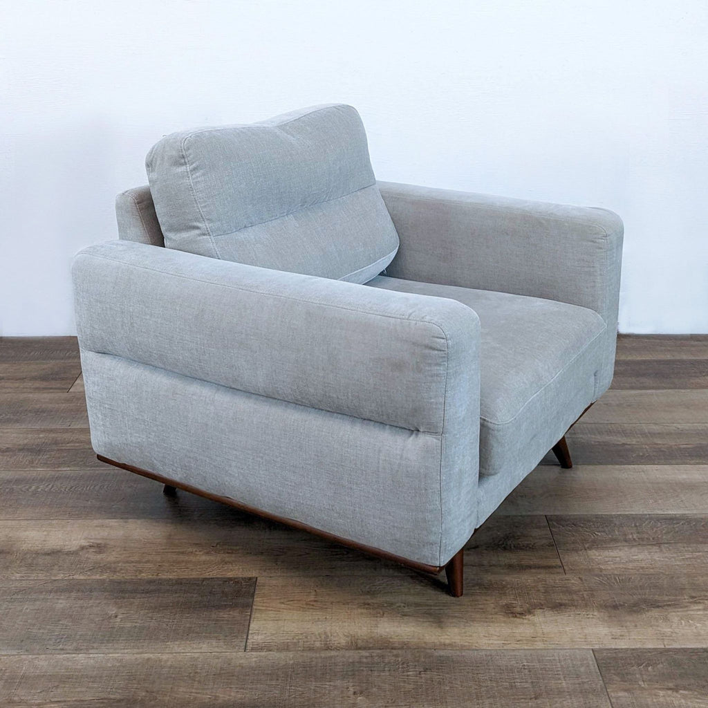 a white couch with a black chair on it 