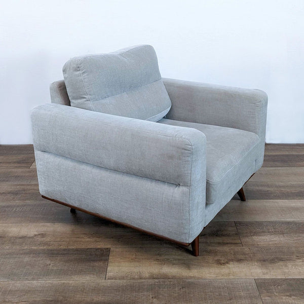 a white couch with a black chair on it 