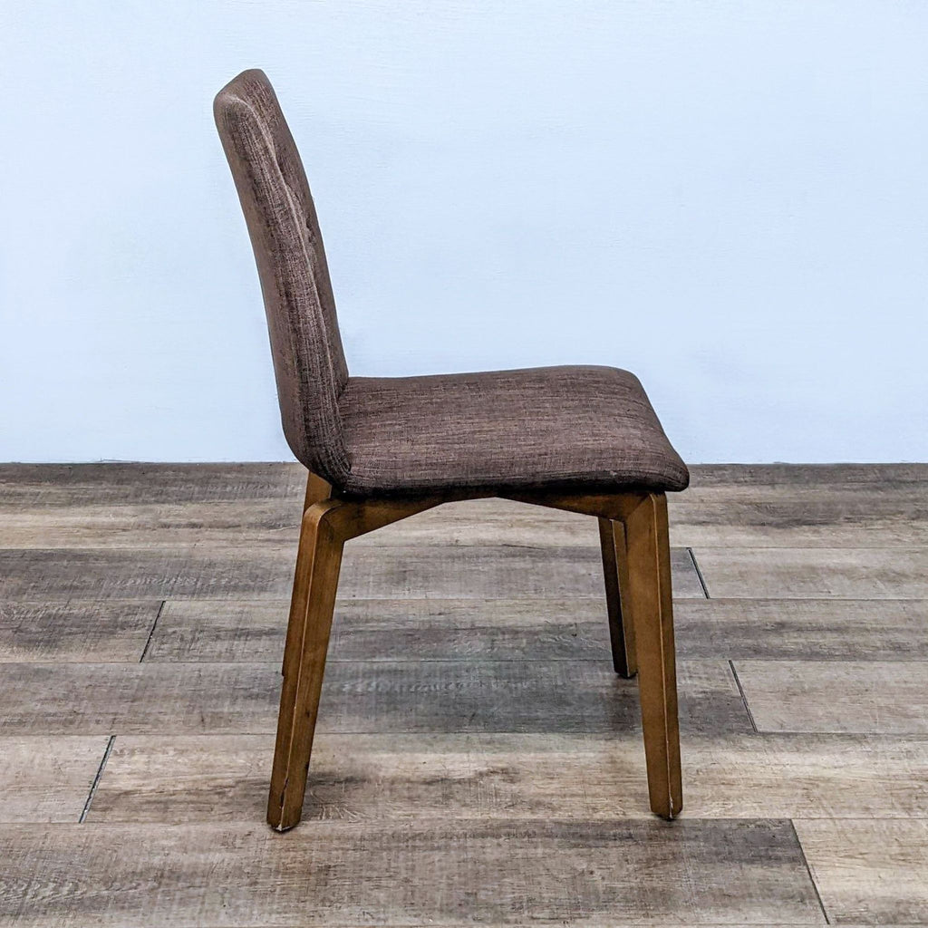 Modern-style Orebro dining chair by Zuo Modern featuring button tufting and a wooden frame with polyester upholstery.