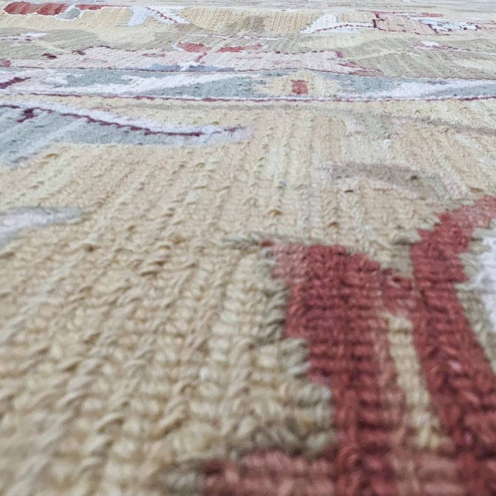 Close-up of the handwoven texture and detailed design of the Nourison Nourmak S174 Gold wool rug showcasing craftsmanship.
