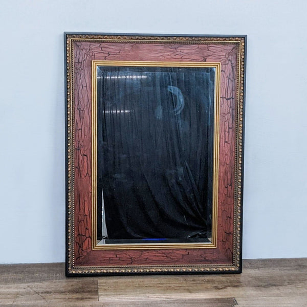 John Richard rectangle beveled wall mirror with a crackle finish frame in black and antique gold.