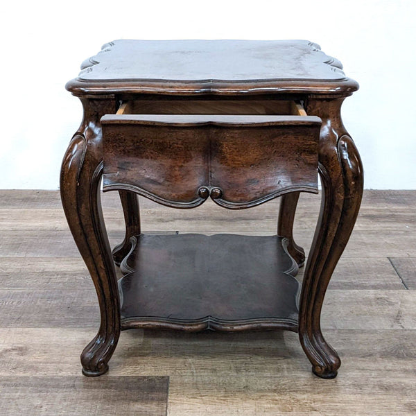 Alt text 1: Thomasville serpentine end table with inlaid top, curvy cabriole legs, and lower shelf, on wooden floor.