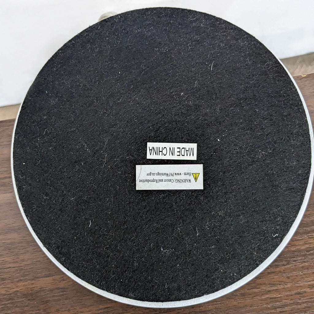 Round black lighting base with a 'Made in China' label, belonging to the Reperch brand.