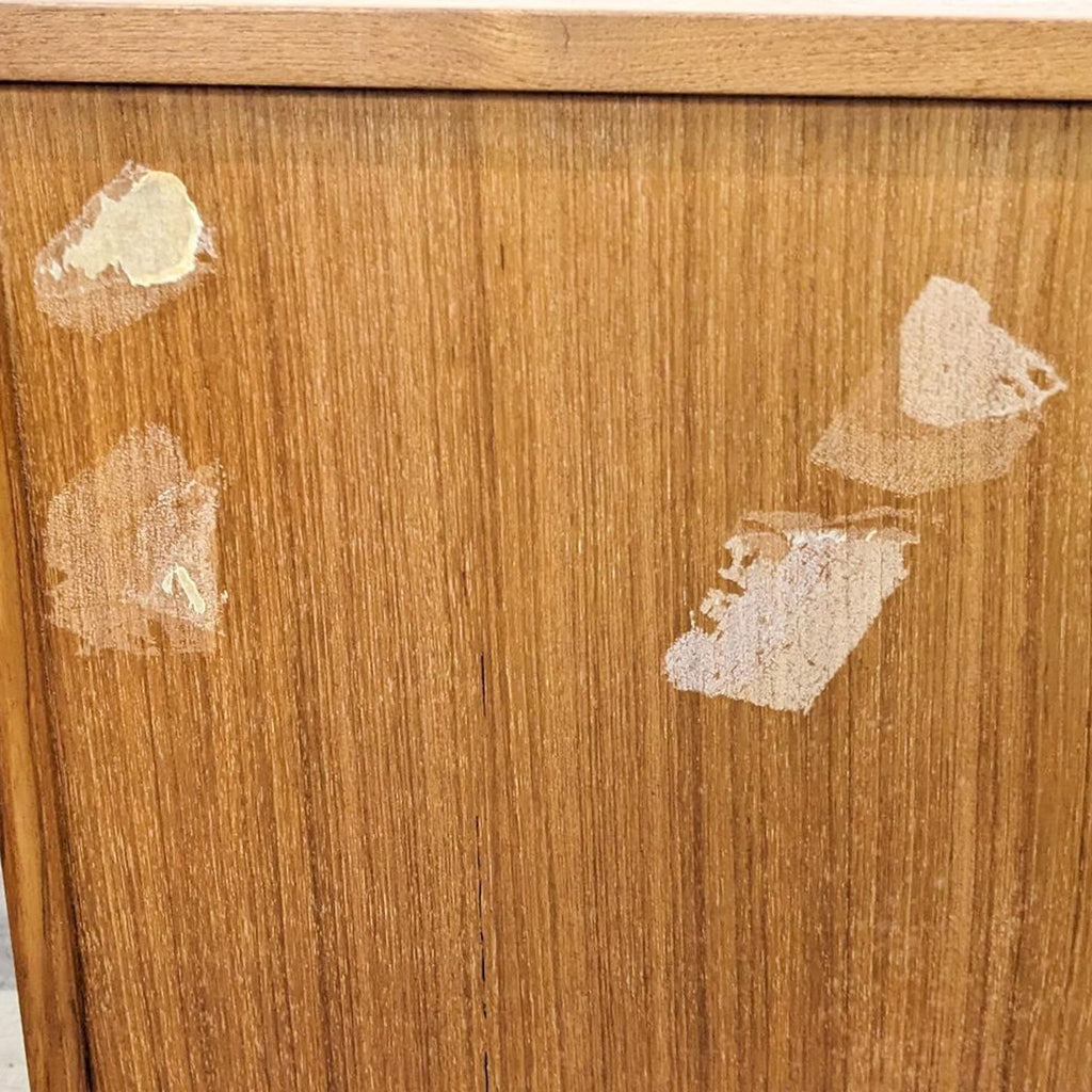 2. Close-up of the Reperch entertainment center highlighting visible scuff marks and surface imperfections on the wood.