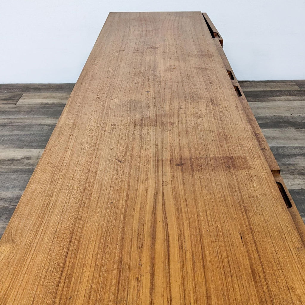 3. Top-down view of the Reperch entertainment center, showing wood grain and noticeable wear on the surface.