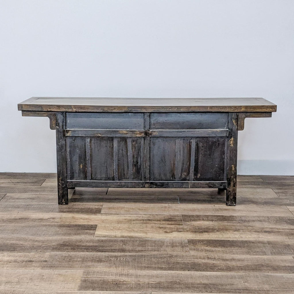 Aged wooden sideboard with iron hardware by GaulSearson Ltd, featuring a dark finish and minimalist design.