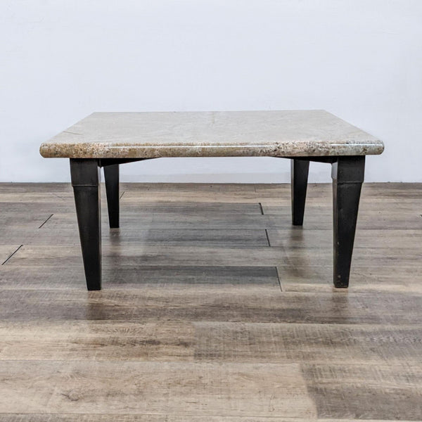 Reperch brand coffee table with a rectangular stone top and metal base, on a wooden floor.