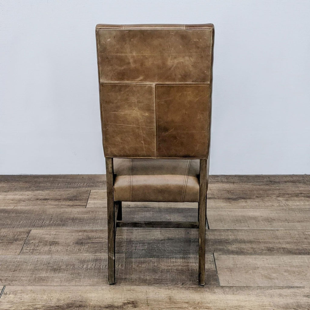 Reperch high back dining chair with wood frame and block style leather upholstery with stitching detail.