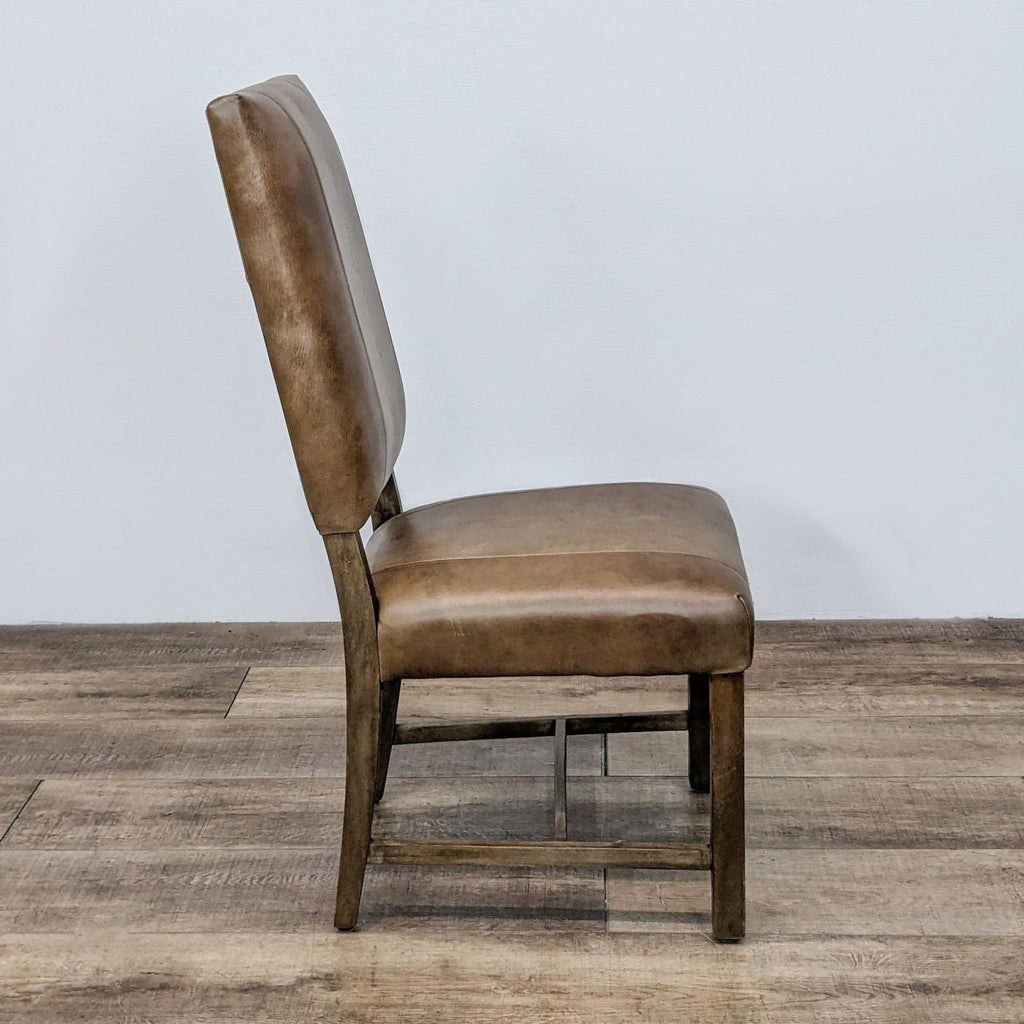 Leather upholstered Reperch dining chair showcasing high back design and wood frame with visible stitching detail.