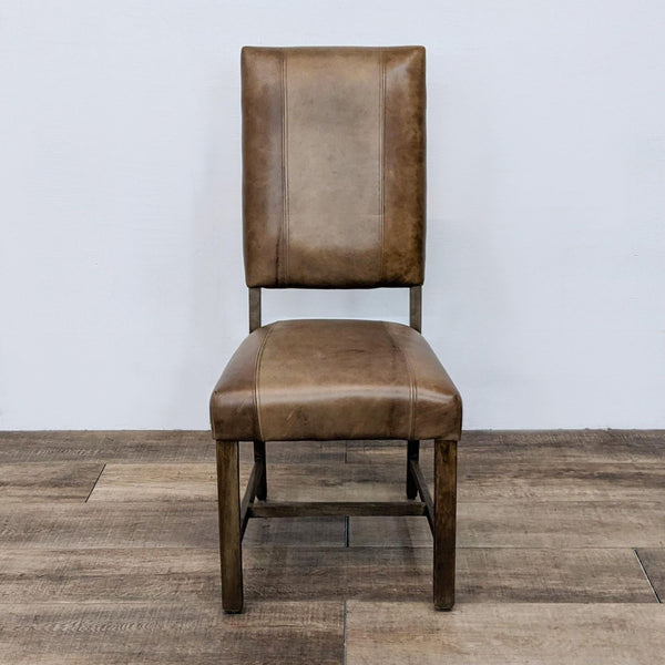 Reperch high back dining chair with wood frame and block style leather upholstery, detailed stitching visible.