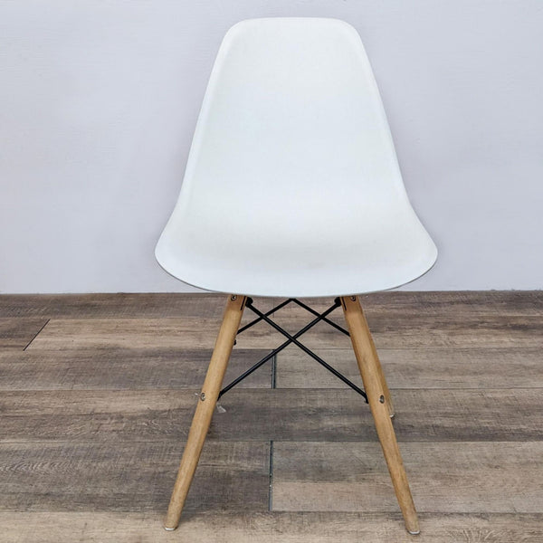 Reperch plastic moulded dining chair with wood and metal Eiffel base, front view.
