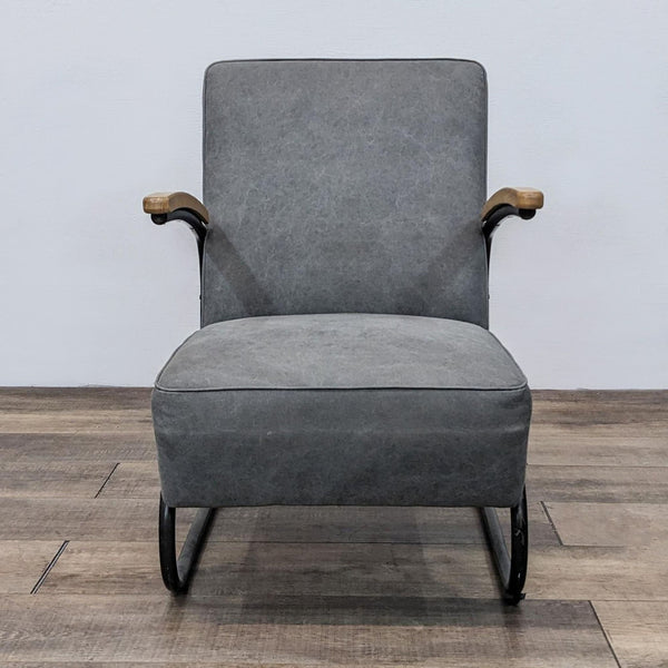 Front view of a Reperch mid-century modern grey armchair with a black steel S-shaped frame and wooden armrests.