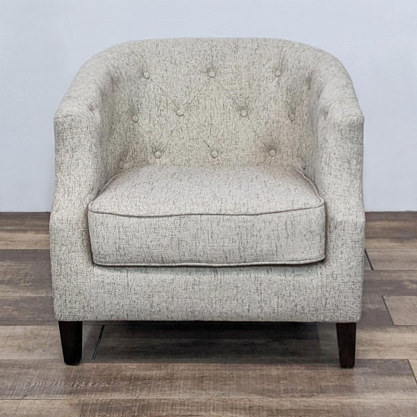 Reperch lounge chair with button tufted back, sloped arms, and tapered wood legs, front view.