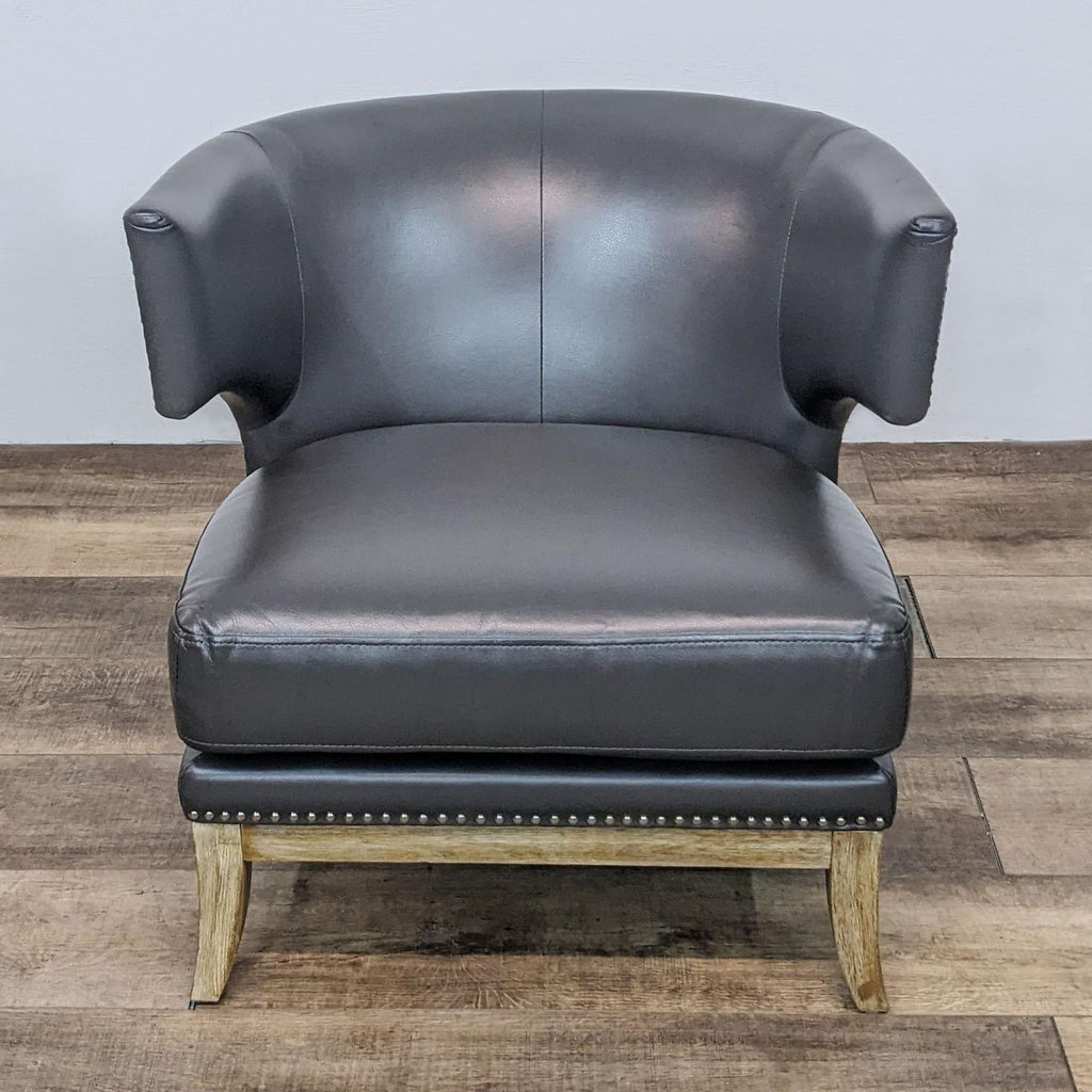Alt text 1: Barrel-back leather Reperch lounge chair, high arms with nailhead details, cutout under armrest, thick seat cushion, flared weathered legs.