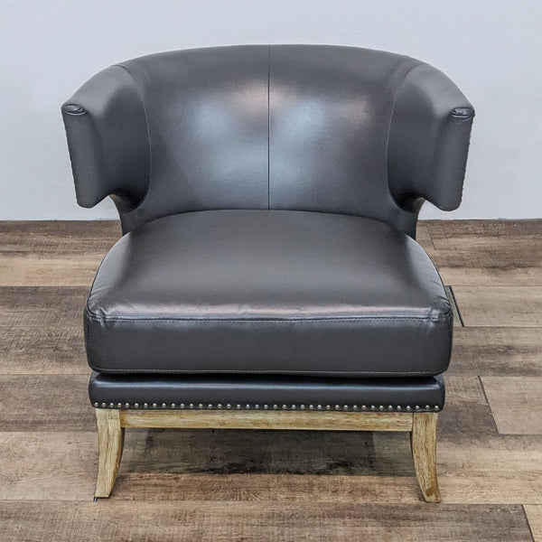 Alt text 1: Barrel-back leather Reperch lounge chair, high arms with nailhead details, cutout under armrest, thick seat cushion, flared weathered legs.