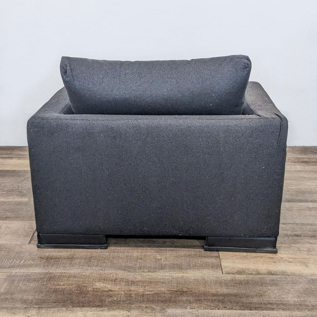 Modern Easytime lounge chair with a minimalist design, steel legs by Reperch with a dark finish, and a sculpted silhouette with removable cushions.