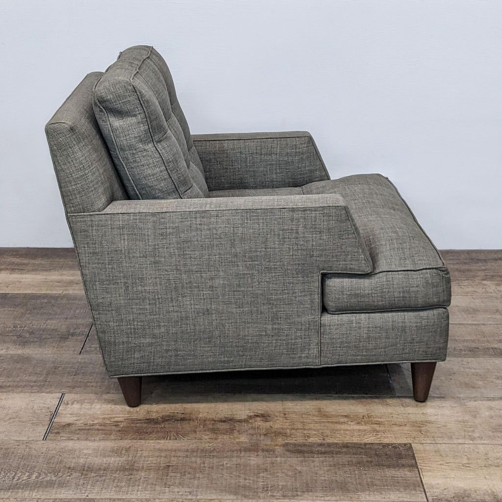 Contemporary Reperch lounge chair shown in three angles, highlighting the tufted cushion, angular arms, and wooden legs.