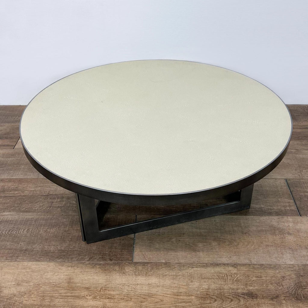 Round coffee table by Burke Decor featuring a textured ivory faux shagreen surface with a sturdy, geometric brass-finish frame.