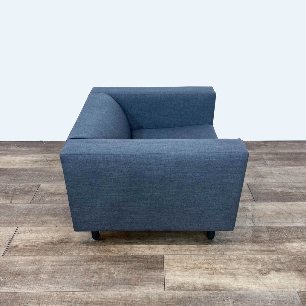 Alt text 2: View of a sleek Mono Lounge Chair with a minimalist design, upholstered in textured blue fabric, by Blu Dot.