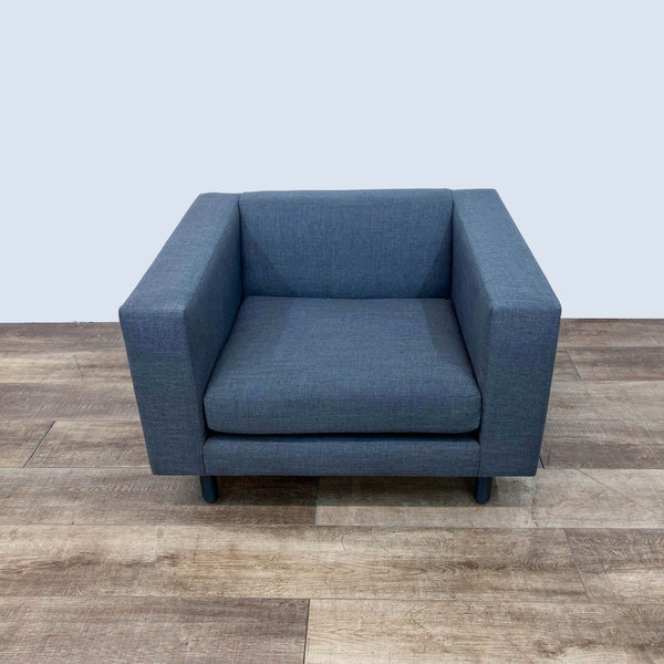 Alt text 1: Mono Chair by Blu Dot in a lounge setting, featuring tapered wooden legs and a blue basket weave fabric upholstery.