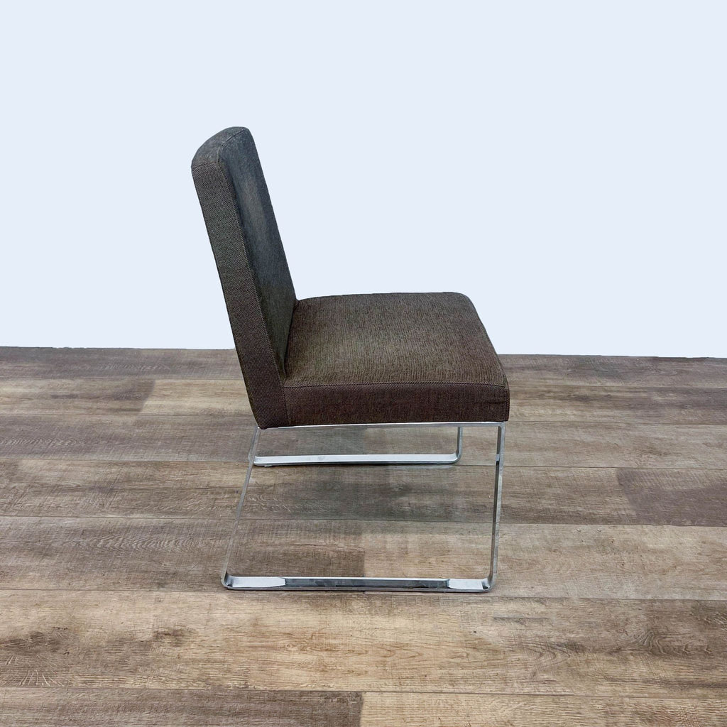 Italian-designed Calligaris dining chair with brown fabric upholstery and steel base, on wooden flooring.