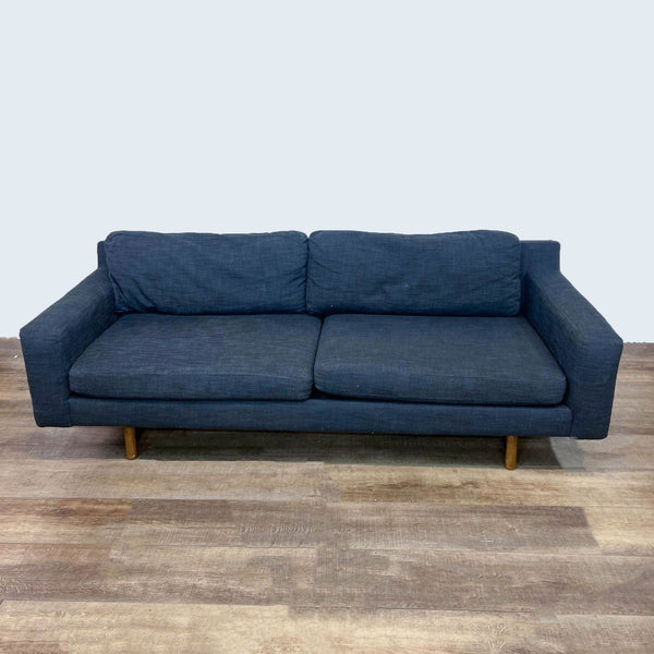 Reperch brand 3-seat sofa with track arms, clean lines, and wood finish feet, shown in frontal view on a wooden floor.