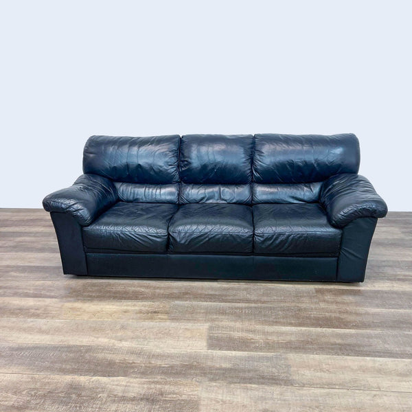 Reperch brand 3-seat high-back leather sofa with plush pillow top arms, depicted in a room with wooden flooring.