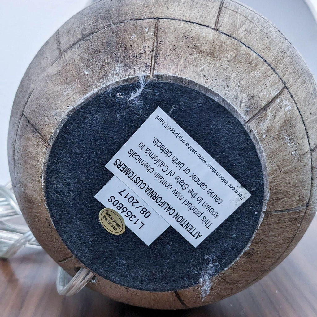 Bottom view of a Reperch brand lighting product showing a wooden base with a product label and sticker.