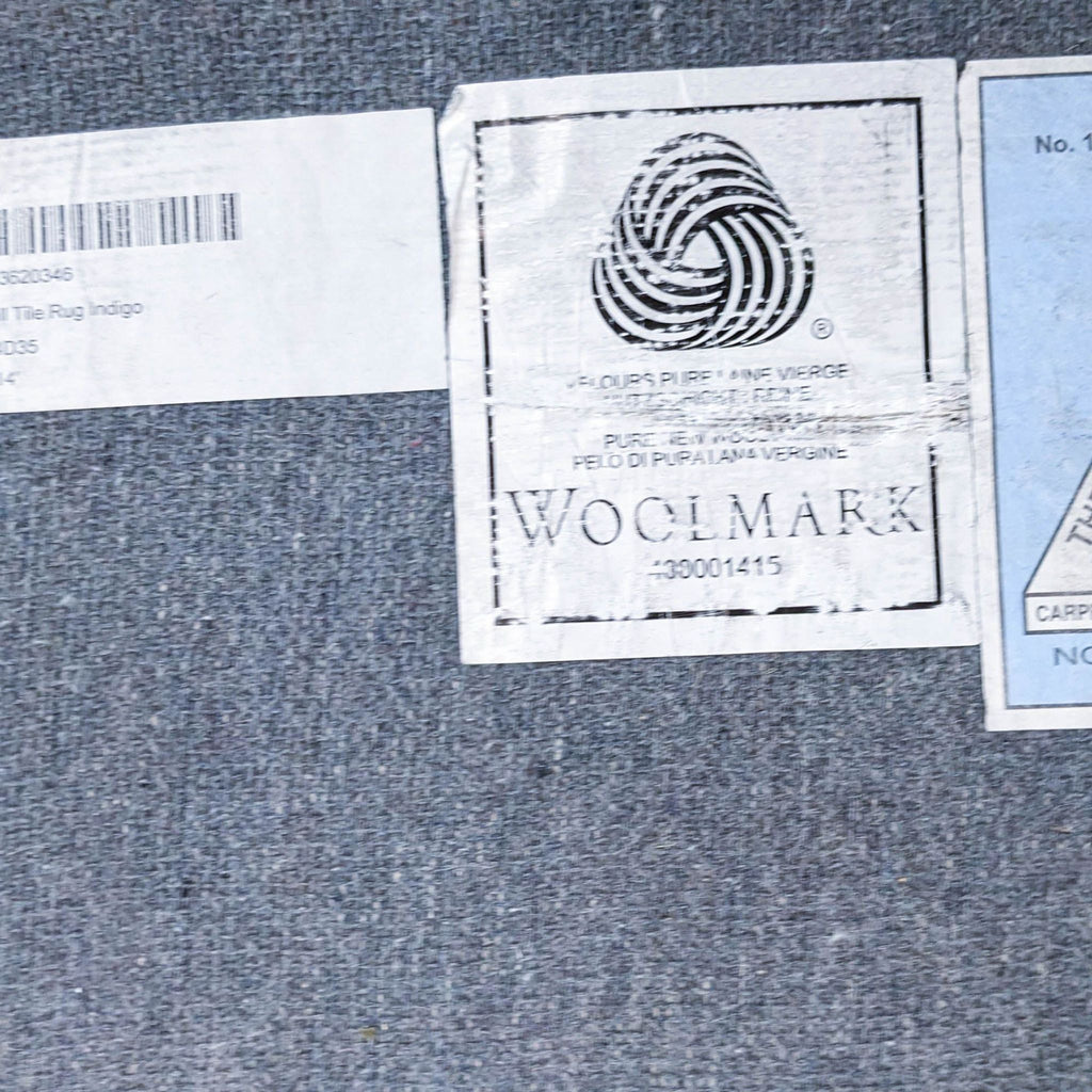 Label of Pottery Barn rug displaying Woolmark certification and product identification on the backside.
