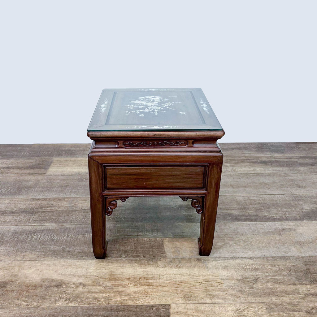 Reperch brand end table with glass protective top and Mother of Pearl inlay on wooden floor.