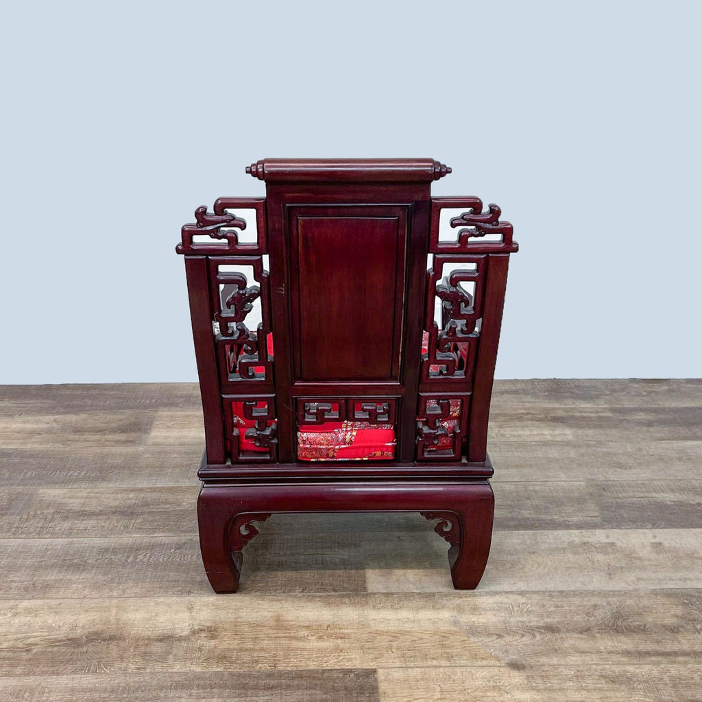 Reperch brand Oriental rosewood armchair with detailed carvings, mother of pearl inlays, and red cushion on floor.