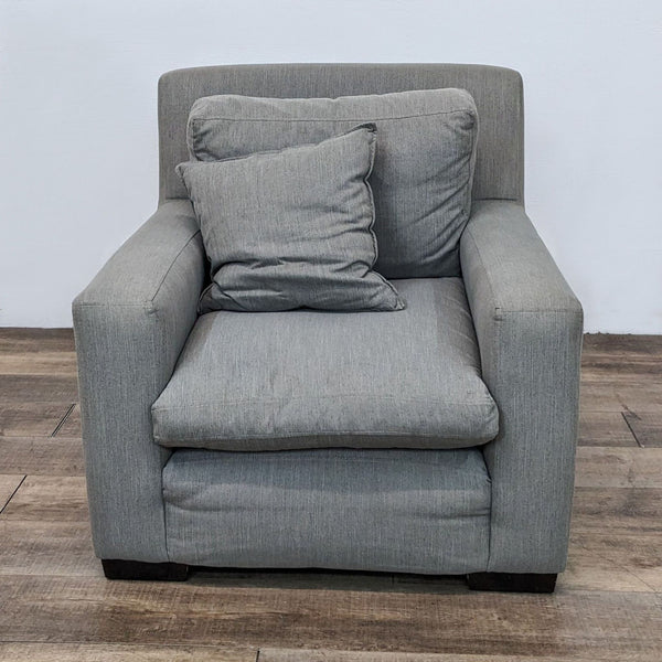 Reperch contemporary lounge chair with gray upholstery, removable cushions, and a matching throw pillow in a frontal view.