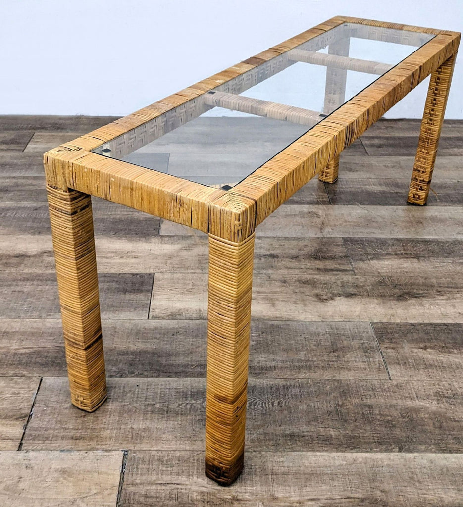 Reperch brand side table with textured wooden legs and a rectangular glass top on a wooden floor.