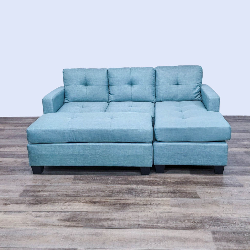 a couch with a blue couch cushions and a black couch cushion 