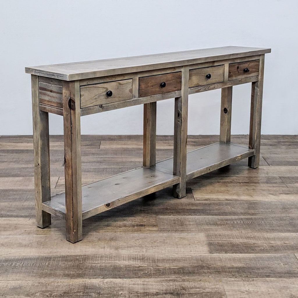 Reperch wooden console table with three drawers and lower shelf on a wood floor.