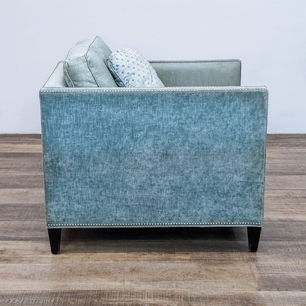 Nailhead-adorned lounge chair by Arhaus Furniture, showcasing boxed arms and textured blue fabric, presented from multiple angles.