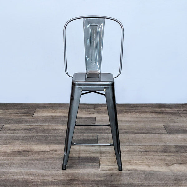 Alt text 1: Xacier Pauchard-designed Tolix stool with high back and steel frame on a wooden floor.