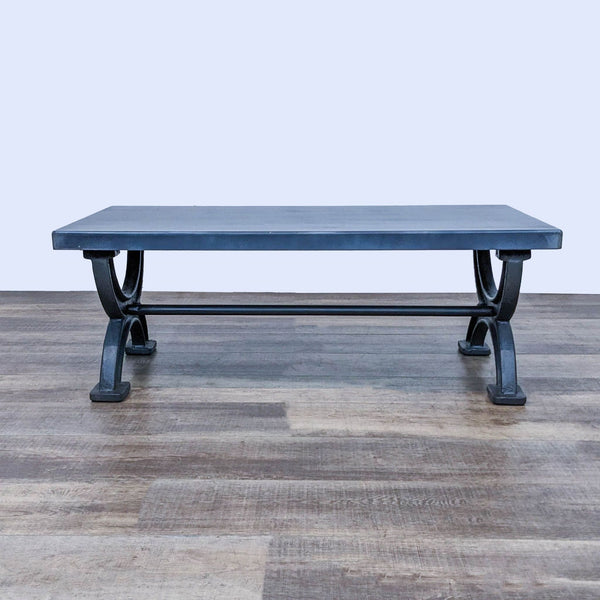 Vintage-inspired, low-slung Restoration Hardware coffee table with sculpted iron X-form legs and a worn patina sheet-metal top.