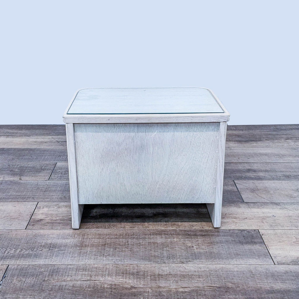 Reperch brand end table with a glass protective top on a wooden floor against a gray background.