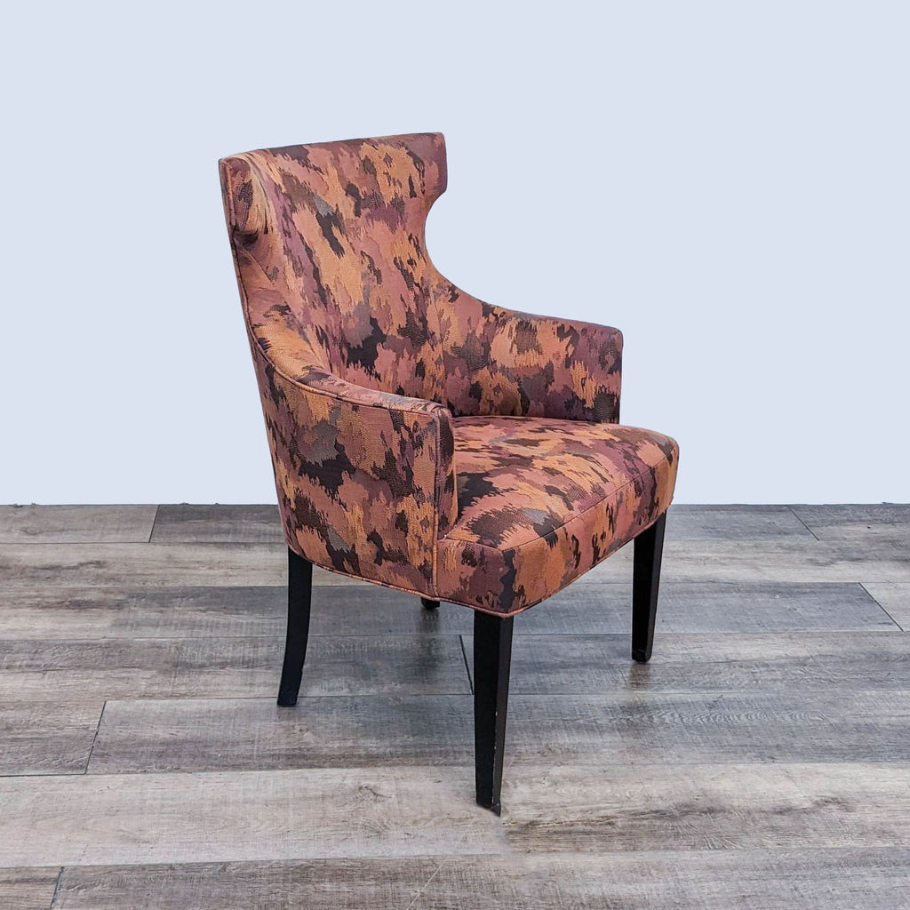 Custom Alinea contemporary wingback chair with a camouflage-like upholstery by Reperch on a wooden floor.