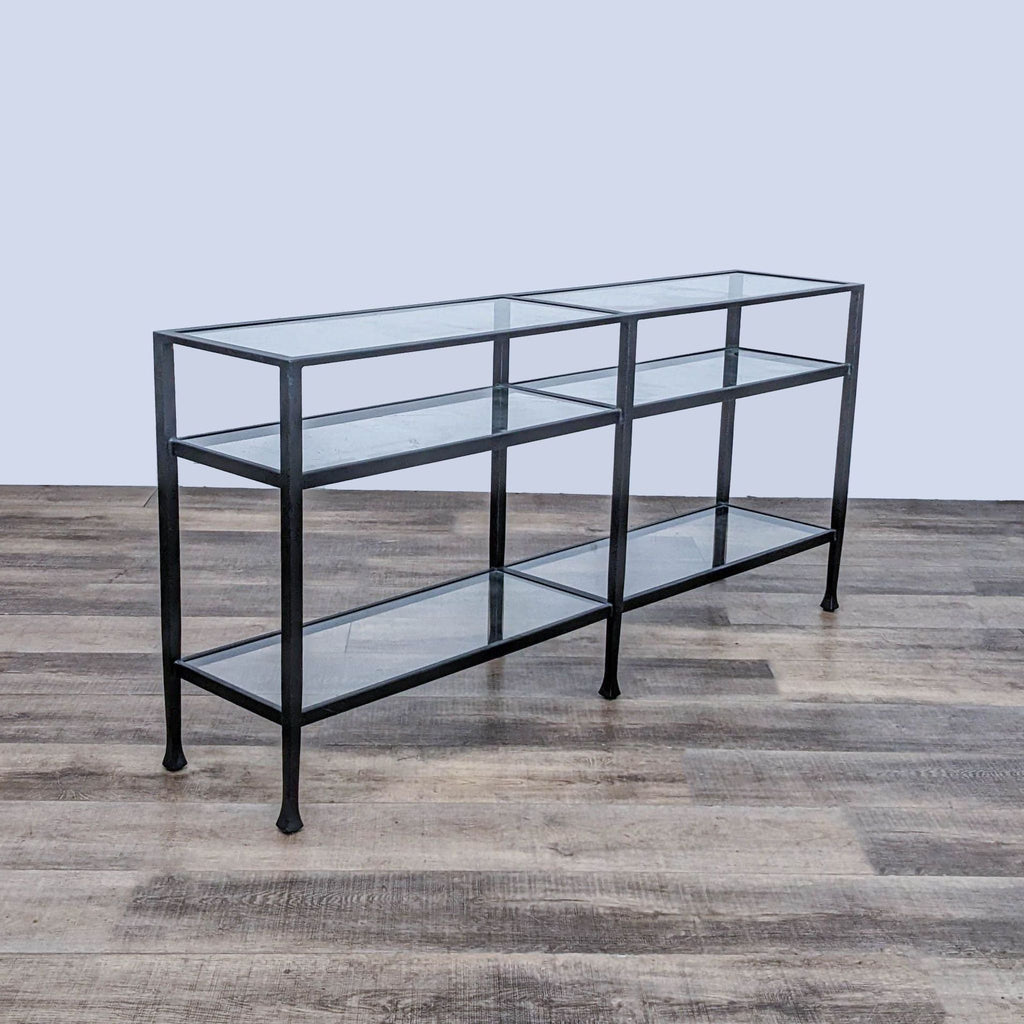 Pottery Barn side table featuring a forged wrought iron frame with a blackened bronze finish and clear tempered glass shelves.