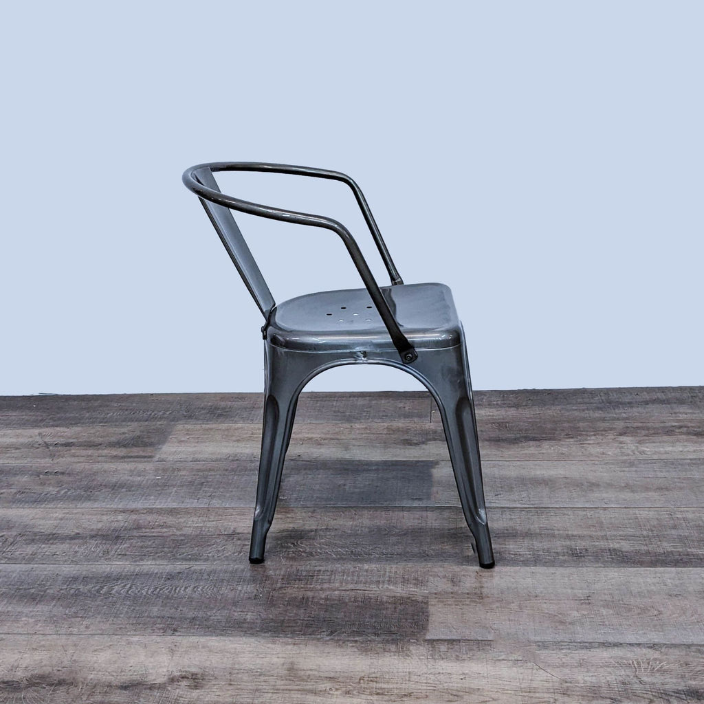 Reperch metal dining chair with ergonomic single slat back, viewed from an angle.