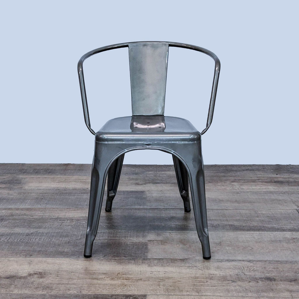 Reperch industrial-style metal dining chair with curved backrest, shown from the front.
