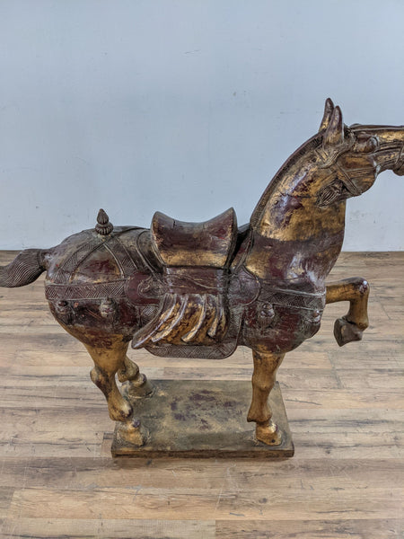 1. "Gilded wood Chinese horse statue by Reperch, showcasing intricate carvings and gold accents, displayed in an indoor setting."